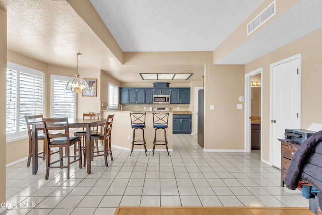 6800 Canyon Run Dr, El Paso, TX 79912 - dining room with a textured ceiling, light tile patterned floors, a chandelier, and baseboards