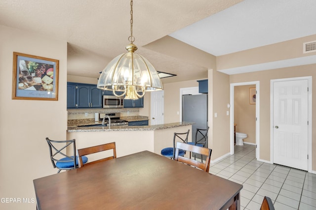 6800 Canyon Run Dr, El Paso, TX 79912 - dining area with a chandelier, light tile patterned floors, and baseboards