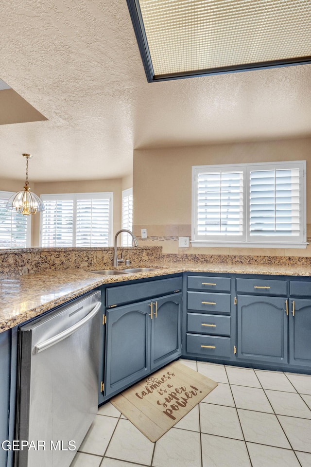 6800 Canyon Run Dr, El Paso, TX 79912 - kitchen featuring dishwasher, a sink, blue cabinetry, a textured ceiling, and light tile patterned floors