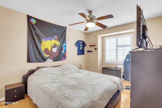 6800 Canyon Run Dr, El Paso, TX 79912 - bedroom featuring wood finished floors, a textured ceiling, and ceiling fan