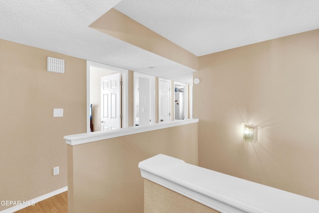 6800 Canyon Run Dr, El Paso, TX 79912 - corridor with baseboards, wood finished floors, and a textured ceiling