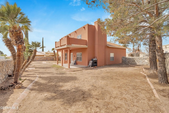 6800 Canyon Run Dr, El Paso, TX 79912 - rear view of property with a balcony, a patio, stucco siding, and a fenced backyard