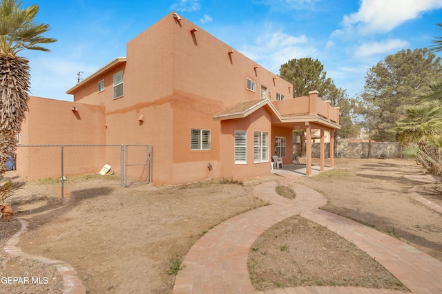 6800 Canyon Run Dr, El Paso, TX 79912 - rear view of property with stucco siding, a gate, and a patio