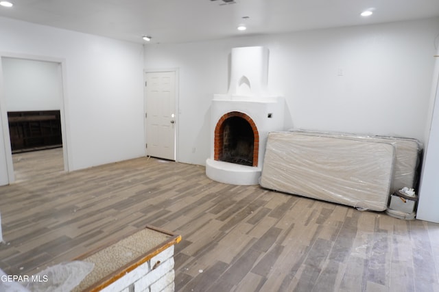 11110 Westside Rd, Anthony, NM 88021 - unfurnished living room featuring a fireplace, wood finished floors, and recessed lighting