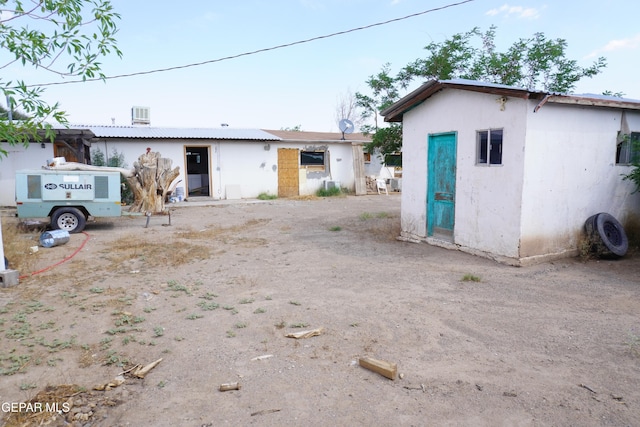 11110 Westside Rd, Anthony, NM 88021 - rear view of property with stucco siding and an outdoor structure
