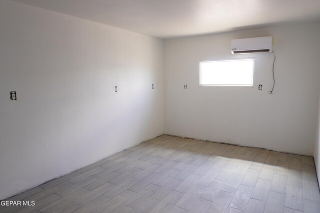 11110 Westside Rd, Anthony, NM 88021 - unfurnished room with a wall unit AC and light wood-style floors