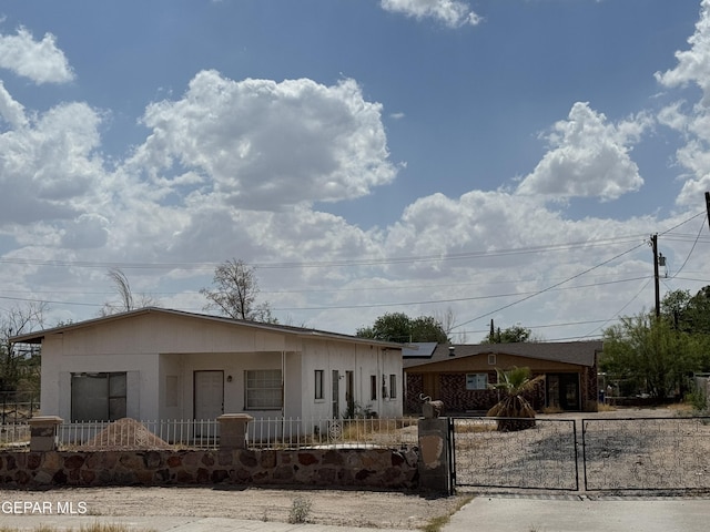 565 Gallagher St, El Paso, TX 79915 - view of front of property with a fenced front yard, covered porch, and a gate
