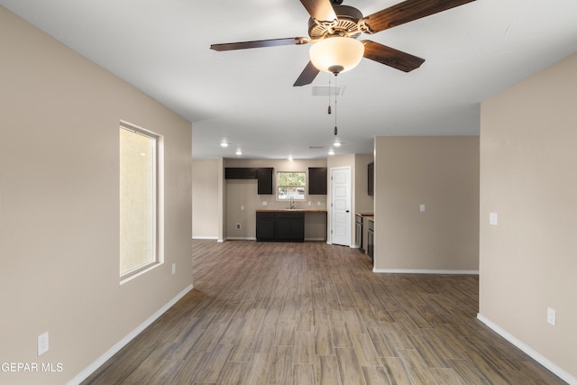 628 Milo Dr, El Paso, TX 79927 - unfurnished living room featuring ceiling fan, wood finished floors, baseboards, and a sink