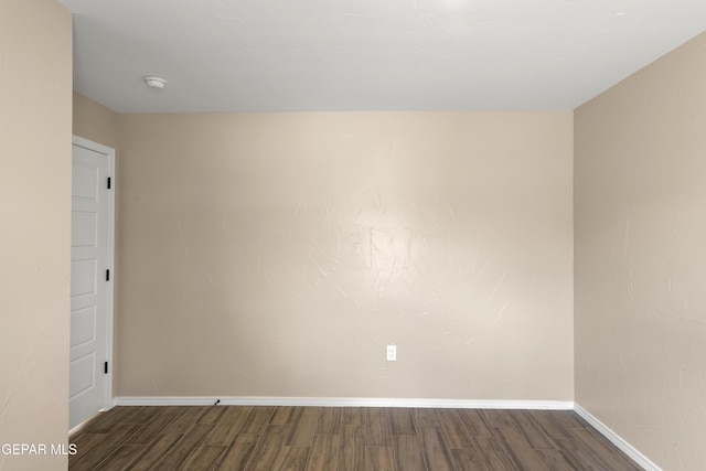 628 Milo Dr, El Paso, TX 79927 - empty room with dark wood finished floors, baseboards, and a smoke detector