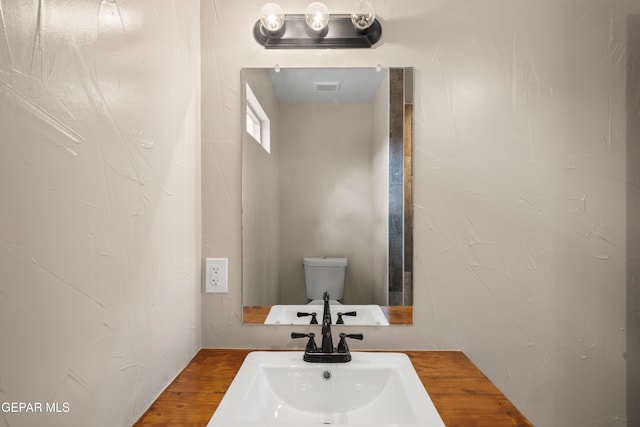 628 Milo Dr, El Paso, TX 79927 - bathroom featuring a sink, toilet, and wood finished floors