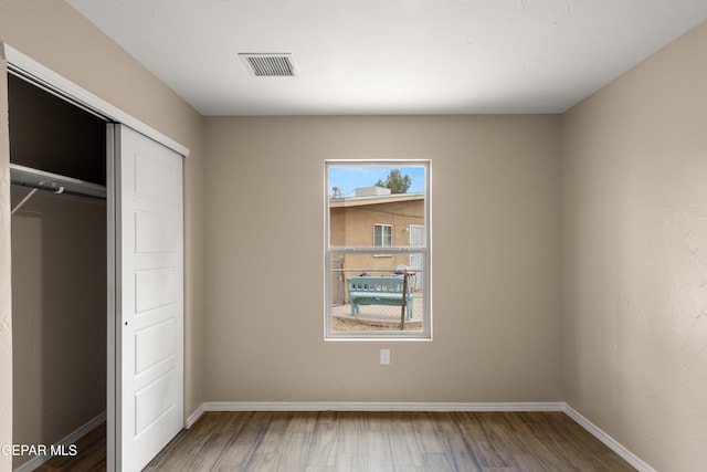 628 Milo Dr, El Paso, TX 79927 - unfurnished bedroom with wood finished floors, baseboards, and a closet