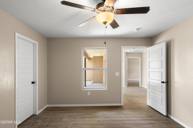 628 Milo Dr, El Paso, TX 79927 - unfurnished room with wood finished floors, a ceiling fan, and baseboards