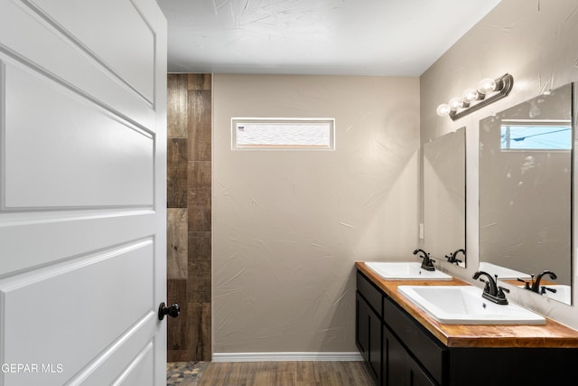 628 Milo Dr, El Paso, TX 79927 - full bathroom with double vanity, wood finished floors, and baseboards
