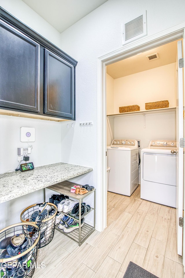 7517 Red Cedar Dr, El Paso, TX 79911 - laundry area featuring washing machine and clothes dryer and light wood-style flooring