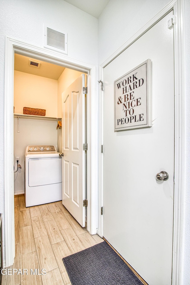 7517 Red Cedar Dr, El Paso, TX 79911 - laundry room featuring washer / clothes dryer and light wood-style flooring