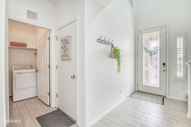7517 Red Cedar Dr, El Paso, TX 79911 - foyer entrance featuring washer / clothes dryer and light wood-style flooring