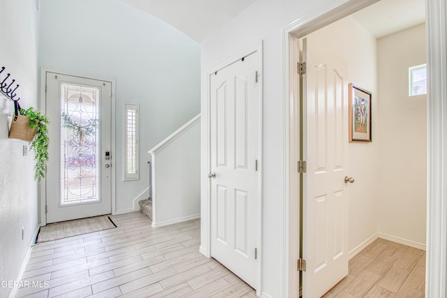 7517 Red Cedar Dr, El Paso, TX 79911 - foyer with light wood-style floors, stairs, baseboards, and vaulted ceiling