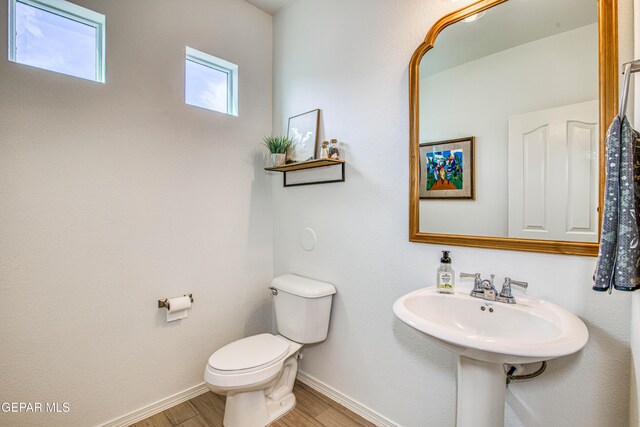 7517 Red Cedar Dr, El Paso, TX 79911 - bathroom featuring toilet, baseboards, and wood finished floors