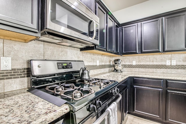 7517 Red Cedar Dr, El Paso, TX 79911 - kitchen with stainless steel appliances, backsplash, and light stone countertops