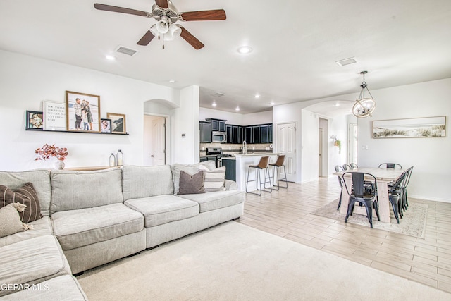 7517 Red Cedar Dr, El Paso, TX 79911 - living room with arched walkways, ceiling fan, recessed lighting, and baseboards