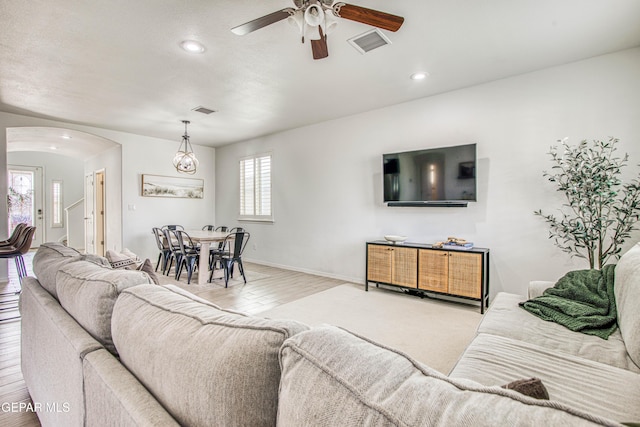 7517 Red Cedar Dr, El Paso, TX 79911 - living room featuring arched walkways, wood finished floors, a ceiling fan, recessed lighting, and baseboards