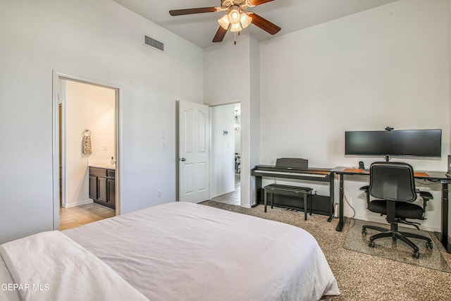 7517 Red Cedar Dr, El Paso, TX 79911 - bedroom with a desk, a towering ceiling, ensuite bathroom, and baseboards