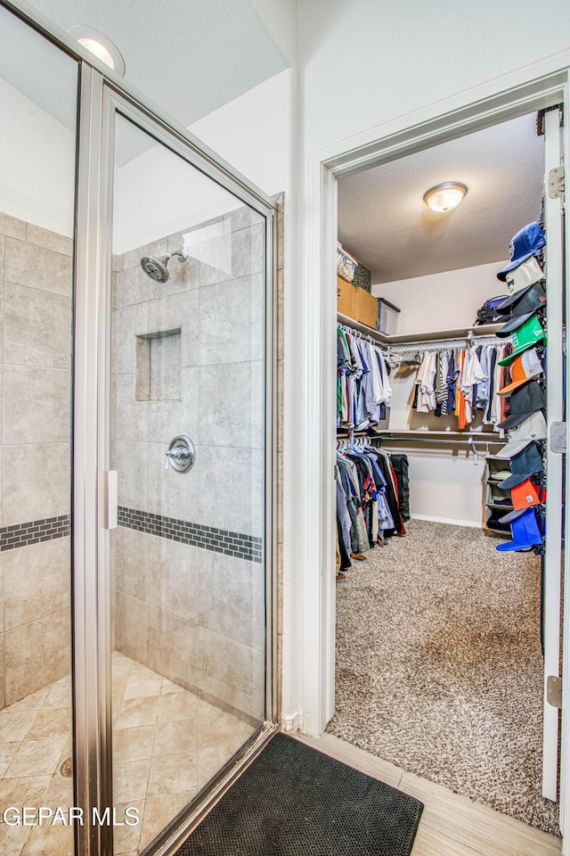 7517 Red Cedar Dr, El Paso, TX 79911 - bathroom featuring a stall shower and a spacious closet