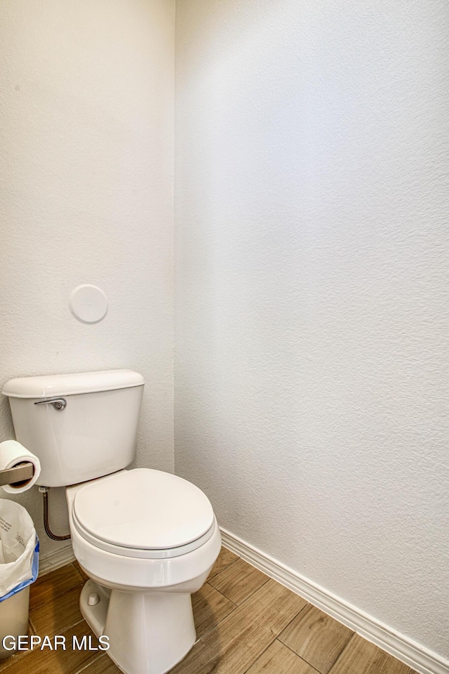 7517 Red Cedar Dr, El Paso, TX 79911 - bathroom featuring toilet, baseboards, and wood finished floors