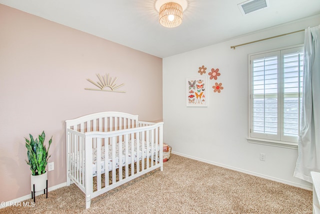 7517 Red Cedar Dr, El Paso, TX 79911 - carpeted bedroom with a crib and baseboards
