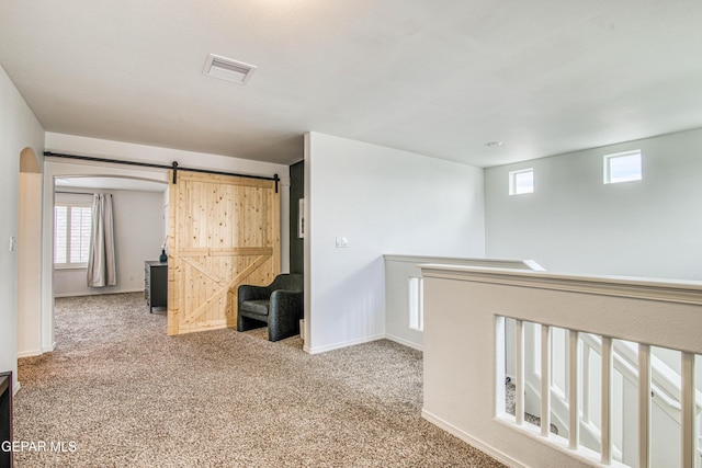 7517 Red Cedar Dr, El Paso, TX 79911 - unfurnished room featuring carpet, a barn door, arched walkways, and baseboards