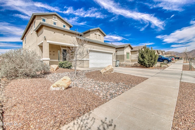 7517 Red Cedar Dr, El Paso, TX 79911 - view of front facade featuring stucco siding, driveway, and a garage