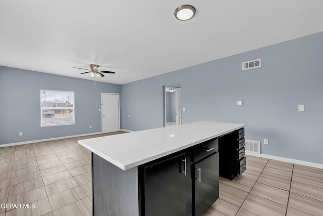 3899 Vanderveer Dr Unit A B C, El Paso, TX 79938 - kitchen featuring a kitchen island, ceiling fan, dark cabinetry, light countertops, and baseboards