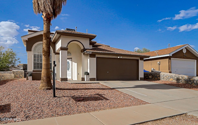 6929 Canyon View Ln, El Paso, TX 79912 - view of front facade with a garage, stucco siding, and driveway