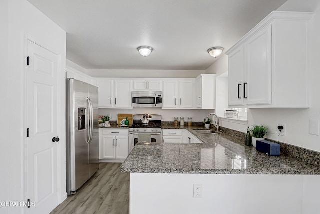 6929 Canyon View Ln, El Paso, TX 79912 - kitchen with stainless steel appliances, a sink, white cabinets, and dark stone countertops