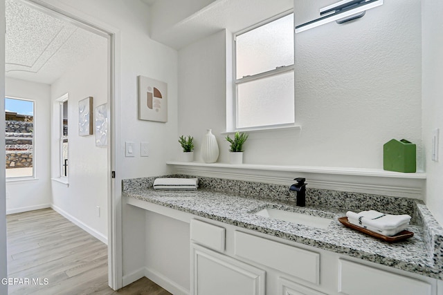 6929 Canyon View Ln, El Paso, TX 79912 - bathroom featuring wood finished floors, vanity, and baseboards