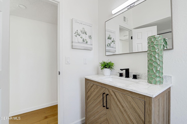 6929 Canyon View Ln, El Paso, TX 79912 - bathroom featuring vanity, wood finished floors, and baseboards