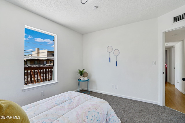 6929 Canyon View Ln, El Paso, TX 79912 - carpeted bedroom featuring a textured ceiling and baseboards
