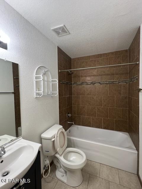 10256 Valle Suave Dr, El Paso, TX 79927 - bathroom featuring toilet, tile patterned flooring, vanity,  shower combination, and a textured ceiling