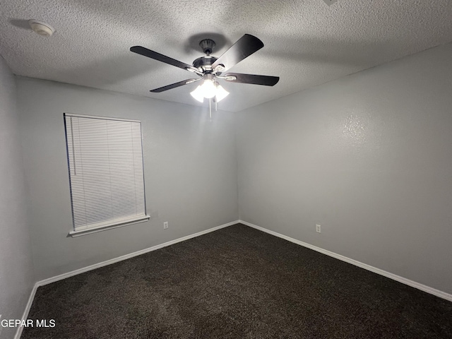 10256 Valle Suave Dr, El Paso, TX 79927 - empty room with ceiling fan, dark carpet, a smoke detector, a textured ceiling, and baseboards