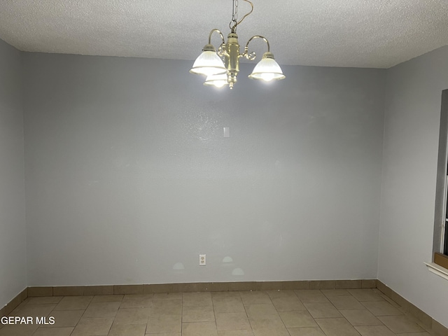 10256 Valle Suave Dr, El Paso, TX 79927 - spare room with a chandelier, a textured ceiling, light tile patterned floors, and baseboards