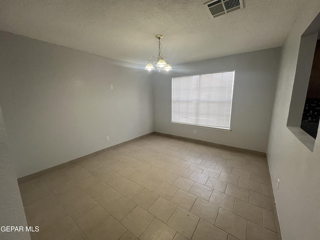 10256 Valle Suave Dr, El Paso, TX 79927 - empty room featuring a chandelier, tile patterned flooring, and a textured ceiling