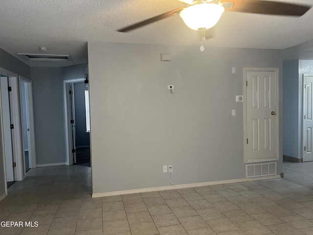 10256 Valle Suave Dr, El Paso, TX 79927 - spare room with a textured ceiling, baseboards, a ceiling fan, and light tile patterned floors