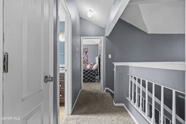 11457 David Carrasco Dr, El Paso, TX 79936 - corridor with a textured ceiling, carpet floors, lofted ceiling, and baseboards
