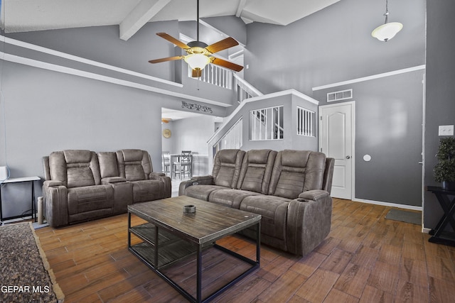 11457 David Carrasco Dr, El Paso, TX 79936 - living area featuring high vaulted ceiling, beam ceiling, a ceiling fan, wood finished floors, and stairs