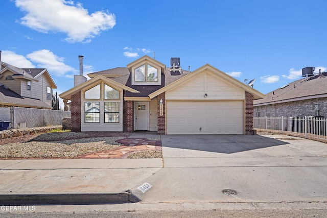 11457 David Carrasco Dr, El Paso, TX 79936 - view of front facade featuring concrete driveway, brick siding, an attached garage, and central AC unit