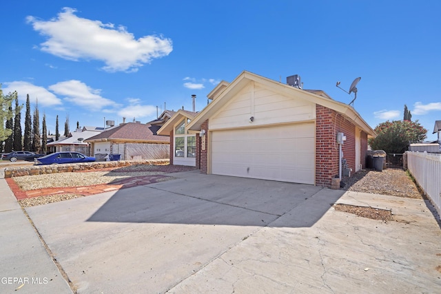 11457 David Carrasco Dr, El Paso, TX 79936 - view of front of property with brick siding, an attached garage, and concrete driveway