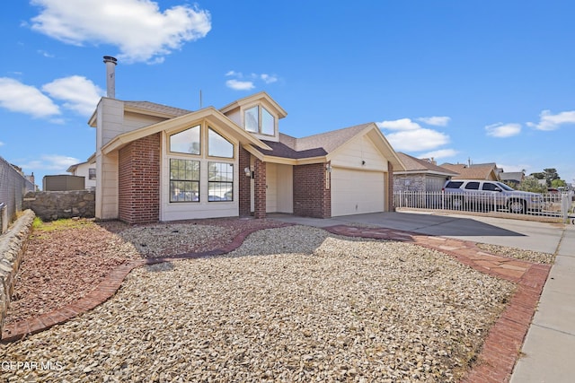 11457 David Carrasco Dr, El Paso, TX 79936 - view of front of property with driveway, brick siding, and a garage