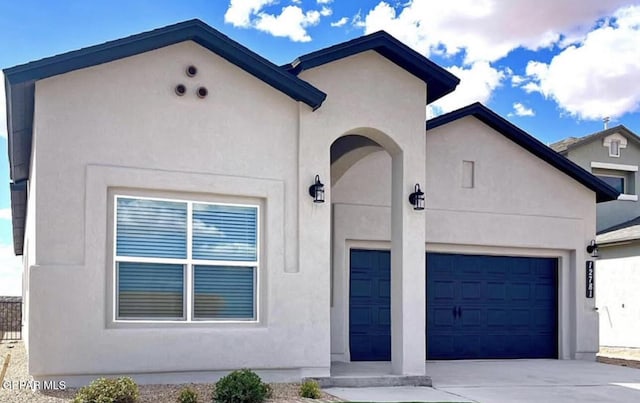 3920 Aspiration St, El Paso, TX 79938 - view of front of house featuring stucco siding, driveway, and a garage