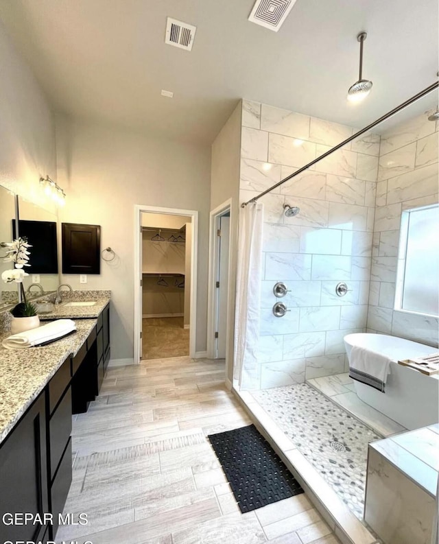 3920 Aspiration St, El Paso, TX 79938 - bathroom featuring a tile shower, double vanity, and a tub
