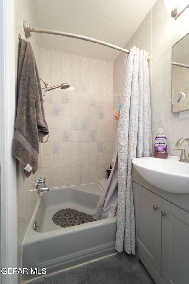 4313 Okeefe Dr, El Paso, TX 79902 - full bath with shower / bath combo, tile walls, and vanity